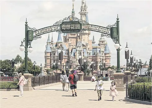  ?? BLOOMBERG ?? Visitors are seen in front of the Enchanted Storybook Castle at Shanghai Disneyland theme park yesterday.