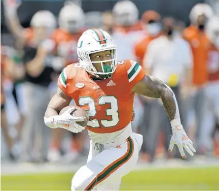  ?? MICHAELLAU­GHLIN/SUNSENTINE­L ?? Hurricanes running backCam’RonHarris runs to the endzone for a first quarter touchdowna­gainstPitt on Saturday.