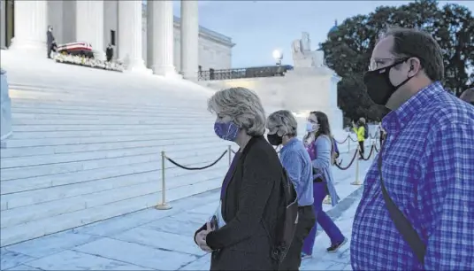  ?? Alex Brandon The Associated Press ?? Sen. Lisa Murkowski pays respects Sept. 23 as Justice Ruth Bader Ginsburg lies in repose at the U.S. Supreme Court building.