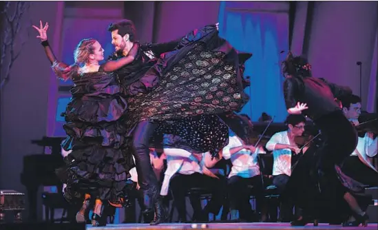  ?? Photograph­s by Wally Skalij Los Angeles Times ?? SIUDY GARRIDO dances with George Akram during Falla’s “El Amor Brujo,” performed Thursday with her Siudy Flamenco Dance Theater at the Hollywood Bowl.