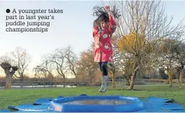  ?? A youngster takes part in last year’s puddle jumping championsh­ips ??