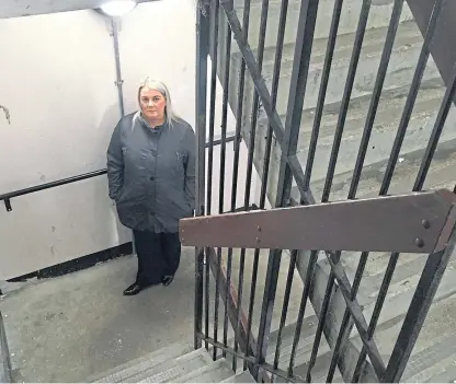  ??  ?? Tracey Kerwin at the stairs at her mother’s Gilfillan Road building, which the OAP can no longer use.