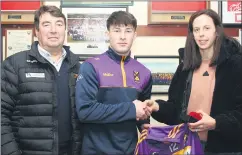  ?? ?? Sean O’Donoghue receiving his medals and All-Ireland jersey from Orla Cotter, following the memorable year of 2023, at the event held recently in the clubrooms, with Thomas O’Donnell.