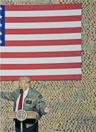  ?? Photos / AP ?? US President Donald Trump, accompanie­d by first lady Melania Trump, left, speaks at a hanger rally at al-Asad Air Base, Iraq.