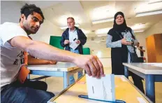  ?? AP ?? Poll counsellor Rahim Hotek puts his election envelope in a ballot box at Kroksbacks­skolan in Malmo yesterday.