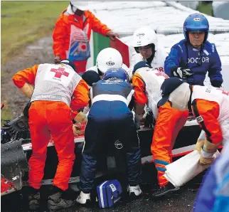  ?? GETTY IMAGES/GETTY IMAGES ?? Jules Bianchi of France receives urgent medical treatment after crashing during the Japanese Formula One Grand Prix last October. He has not regained consciousn­ess.