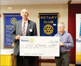  ?? ?? Rotary President John Forde presents Joel Downey with Starkville Habitat for Humanity with $3,000 from the Rotary grant. (Photo by Jessica Lindsey, SDN)