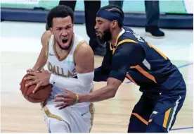  ?? KEVIN JAIRAJ/USA TODAY SPORTS ?? Mavericks guard Jalen Brunson (13) drives to the basket as Jazz guard Mike Conley (10) defends on Monday in Dallas.