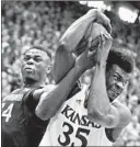  ?? CHARLIE RIEDEL/AP ?? West Virginia’s Oscar Tshiebwe, left, fights for the ball with Kansas’ Udoka Azubuike.