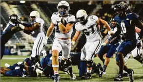  ?? Kevin Ortiz / UConn Athletics ?? UConn running back Victor Rosa carries the ball against FIU on Saturday.