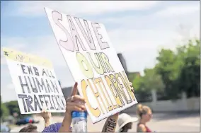  ??  ?? People march during a “Save the Children” rally Aug. 22 outside the Capitol building in St Paul, Minn. [STEPHEN MATUREN/GETTY IMAGES]