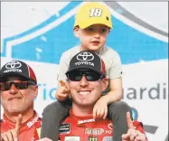  ?? Ralph Freso / Associated Press ?? Kyle Busch and his son Brexton celebrate in Victory Lane after winning the NASCAR Cup Series race Sunday at ISM Raceway in Avondale, Ariz.