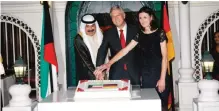  ??  ?? KUWAIT: (From left) Kuwait’s Deputy Foreign Minister Khaled AlJarallah, German Ambassador to Kuwait Karlfried Bergner and the ambassador’s spouse cut the cake at a ceremony to celebrate Germany’s national day. —Photos by Joseph Shagra