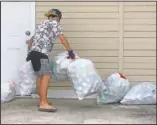  ??  ?? Genshu collects recyclable cans and bottles for his fundraiser Bottles4Co­llege. Genshu started Bottles 4College three years ago to raise money for his own tuition but has since expanded the recycling project to benefit other students.