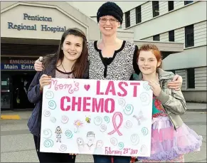  ?? Special to The Herald ?? Breast cancer patient Brenda Coffin is joined by her daughters Chloe, left, and Gracie after recently completing her chemothera­py treatment at Penticton Regional Hospital.