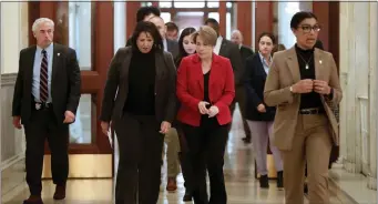  ?? NANCY LANE — BOSTON HERALD ?? Gov. Maura Healey heads to her office after speaking to the media at the State House on Monday. She vowed to keep the pressure on over Cape bridges.