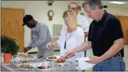  ?? Diane Wagner / Rome News-Tribune ?? Members of the Rome-Floyd Parks & Recreation board Ralph Davis Jr. (from left), Bob Williams, Kara Kilgo and Chairman Spencer Brewer fill their lunch plates before Tuesday’s meeting at the Charles C. Parker Senior Center.