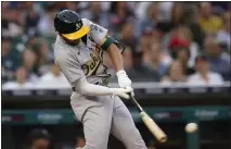  ?? PAUL SANCYA — THE ASSOCIATED PRESS ?? The A's Kevin Smith hits a two-run double against the Detroit Tigers in the third inning in Detroit on Wednesday.