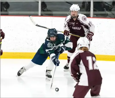  ?? Photos by Michelle Menard ?? Burrillvil­le senior Maddie McCutcheon, above, attempts to get control of the puck during BPBV’s 9-3 Division place La Salle Thursday night. Below, La Salle goalie Sarah Lisa tries to stop a Bronco shot.
I defeat to first