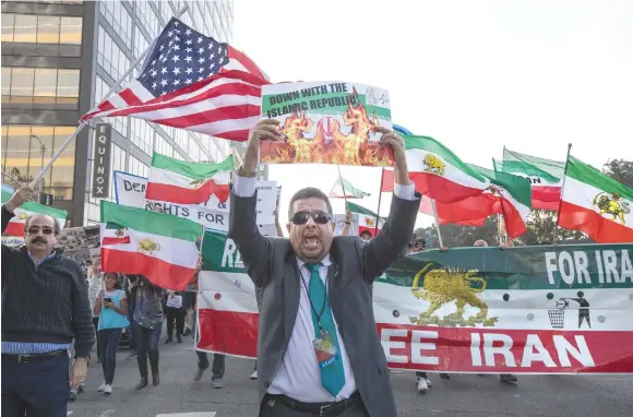  ?? (Monica Almeida/Reuters) ?? PEOPLE RALLY in support of Iranian anti-government protests in Los Angeles over the weekend.