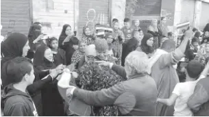  ??  ?? Scenes from polling stations across the country showed women of all ages from impoverish­ed social classes dancing, singing, and chanting for Al-Sisi