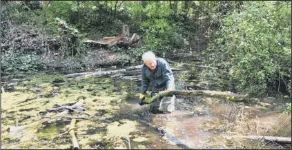  ??  ?? mess: Mick Russell says vandals and fly-tippers are ruining the pond for everyone.
Picture: ROW-