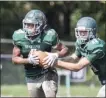  ?? JOHN BLAINE — FOR THE TRENTONIAN ?? Steinert quarterbac­k Nick Wright (11) hands off to running back Will Laster (4) during a game against Notre Dame. Wright and Laster are the returning playmakers on the roster.