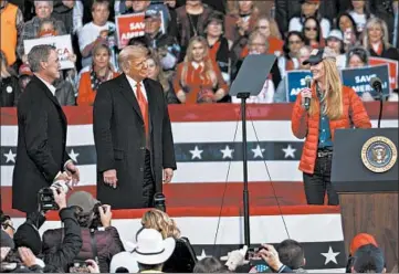  ?? BEN GRAY/AP ?? President Donald Trump takes the stage Saturday with GOP Sens. David Perdue, left, and Kelly Loeffler, both of Georgia.