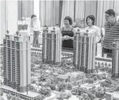  ?? GILLES SABRIÉ NYT FILE ?? A model of one of Evergrande’s housing projects is displayed at a showroom in Dongguan, China.