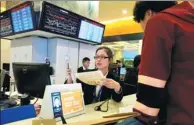  ?? GAO ERQIANG / CHINA DAILY ?? A business owner applies for a license at the Government Affairs Center of the Free Trade Zone of Pudong New District. Shanghai. on Nov 28.