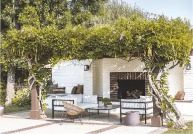  ??  ?? GARDEN Wisteria has been trained over a frame for a shady fireside space. Outdoor coffee table,
Nickey Kehoe. Wicker
chair, Amsterdam Modern