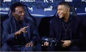  ?? — AP ?? You can do it: Brazilian legend Pele (left) and French player Kylian Mbappe joke during a sponsor event for Hublot in Paris on Tuesday.