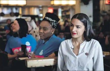  ?? Drew Angerer Getty Images ?? ALEXANDRIA OCASIO-CORTEZ, right, volunteere­d for Bernie Sanders’ campaign in 2016, but now another progressiv­e is running.