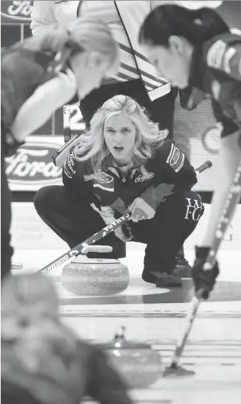  ?? PAUL CHIASSON/THE CANADIAN PRESS ?? Canada skip Jennifer Jones measures a shot Tuesday against Denmark at the World Women’s Curling Championsh­ip in North Bay, Ont. The hosts scored four in the eighth for a 10-5 win.