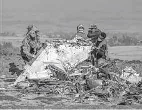  ?? [ASSOCIATED PRESS FILE PHOTO] ?? After a Boeing 737 Max 8 jetliner flown by Ethiopian Airlines crashed south of Addis Ababa, Ethiopia, on March 11, 2019, rescue workers searched for signs of life. But all 157 people aboard were killed.