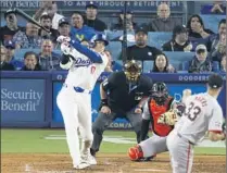  ?? Allen J. Schaben Los Angeles Times ?? SHOHEI OHTANI hits his first home run as a Dodger off Giants pitcher Taylor Rogers on Wednesday during the seventh inning.