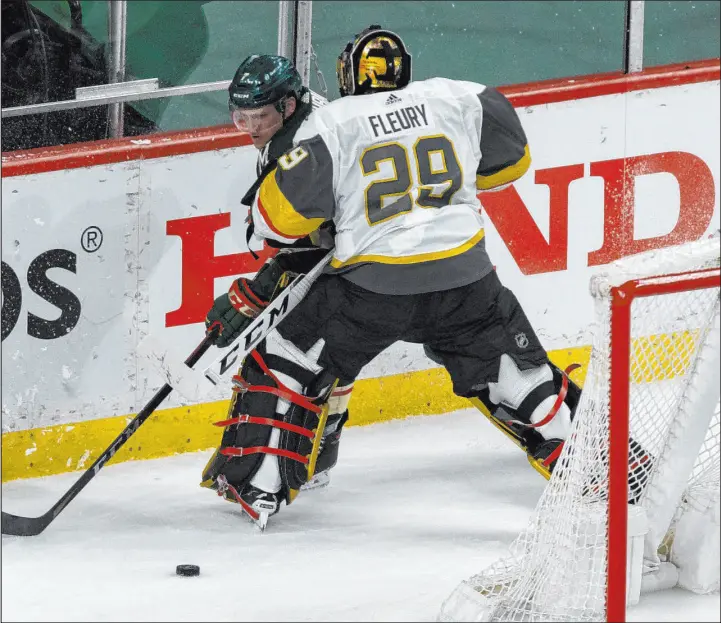  ?? Andy Clayton-king The Associated Press ?? Golden Knights goalie Marc-andre Fleury plays behind the net against Wild center Nico Sturm in the first period of Saturday’s West Division semifinal victory in St. Paul, Minn.