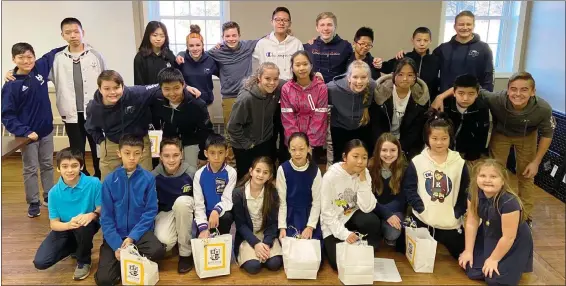  ?? SUBMITTED PHOTOS ?? Pictured with their American student ambassador­s, 14Chinese students came to America for a three-week educationa­l and cultural experience Jan. 17to Feb. 7at High Point Academy in Geigertown.