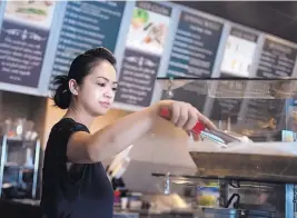  ?? ROBERTO E. ROSALES/JOURNAL ?? Uyen Nguyen, co-owner of the Coda Bakery in the Internatio­nal District, works during a recent lunch hour.