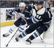  ?? JAY LAPRETE — THE ASSOCIATED PRESS ?? Columbus’ Vladislav Gavrikov, right, tries to clear the puck as Winnipeg’s Mason Appleton defends in the third period.