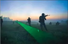  ?? MU RUILIN / FOR CHINA DAILY; ?? on June 28, 2018, soldiers conduct a tactical exercise on the Weibei Plateau.