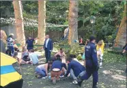 ?? HELDER SANTOS / AGENCE FRANCE-PRESSE ?? People help those who were injured after a 200-year-old oak tree fell at a religious festival on the Portuguese island of Madeira on Tuesday. At least 11 people were crushed to death, local media reported.