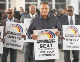  ?? Scott Olson / Getty Images ?? The Rev. Jesse Jackson leads a group in Chicago, protesting United Airlines.