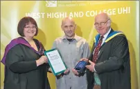  ??  ?? College principal and chief executive of West Highland College UHI, Lydia Rohmer, and chairman of the West Highland College UHI John Hutchison presents the Further Education Student of the Year award to Craig Muir, from Broadford.