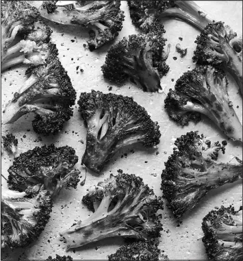  ?? YOSSY AREFI / THE NEW YORK TIMES ?? Roasted broccoli with vinegar-mustard glaze can be paired as a side dish with meat or standout with white beans as part of a complete meal.