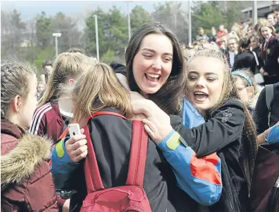  ?? Picture: Gareth Jennings. ?? Daisy George, 15, is embraced by friends.