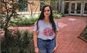  ?? BRAD SCHRADE / AJC ?? University of Georgia student Jessica Douglas stands in a new courtyard entrance near Baldwin Hall where slave remains were discovered in 2015. Douglas is pushing for UGA to acknowledg­e its ties to slavery.