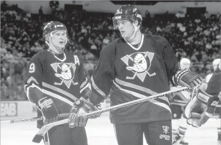  ?? Bruce Bennett Getty Images ?? FORMER TEAMMATES and linemates Paul Kariya, left, and Teemu Selanne complement­ed each other when they played for the Ducks.