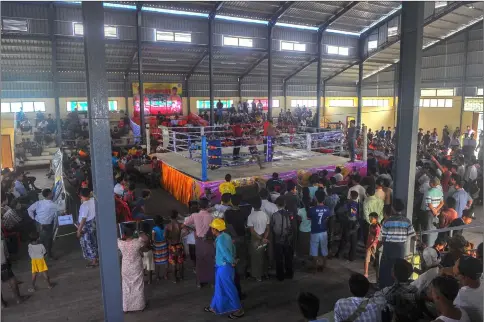  ??  ?? Local spectators watch a ground-breaking Lethwei competitio­n.