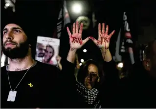  ?? ?? Relatives and supporters of the Israeli hostages held in Gaza by the Hamas militant group attend a protest calling for their release outside the Knesset, Israel’s parliament, on Monday. “Time is running out,” one protester wrote on her hands in Hebrew. Frustratio­n has been mounting over Prime Minister Benjamin Netanyahu’s management of the war.